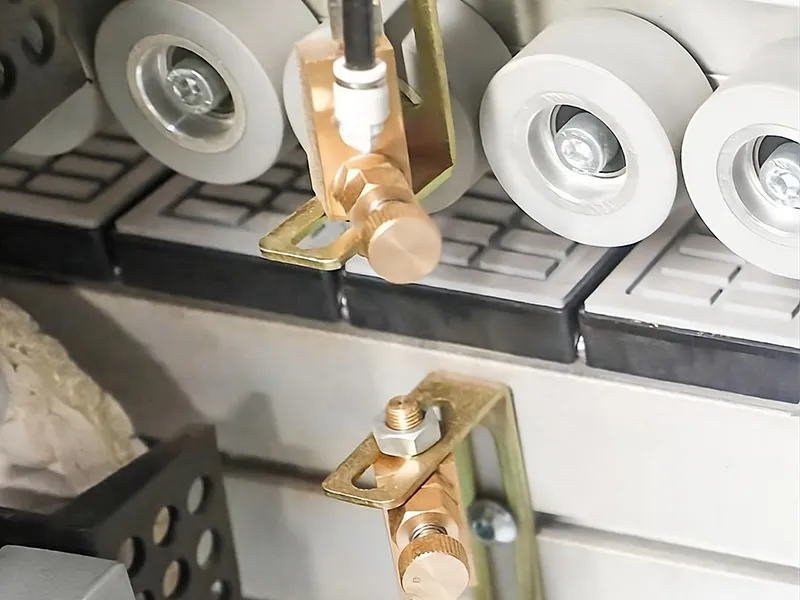 HE-668-SG-PUR dual-nozzle spraying system atomizing cleaning agent to chemically dissolve stubborn PUR adhesive residue before buffing.